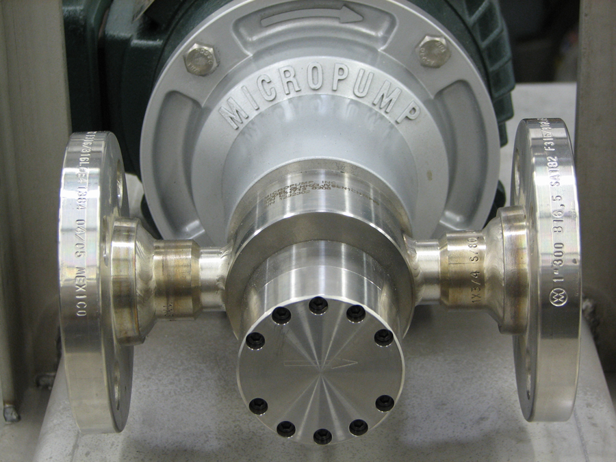 Micropump with custom welded flanges